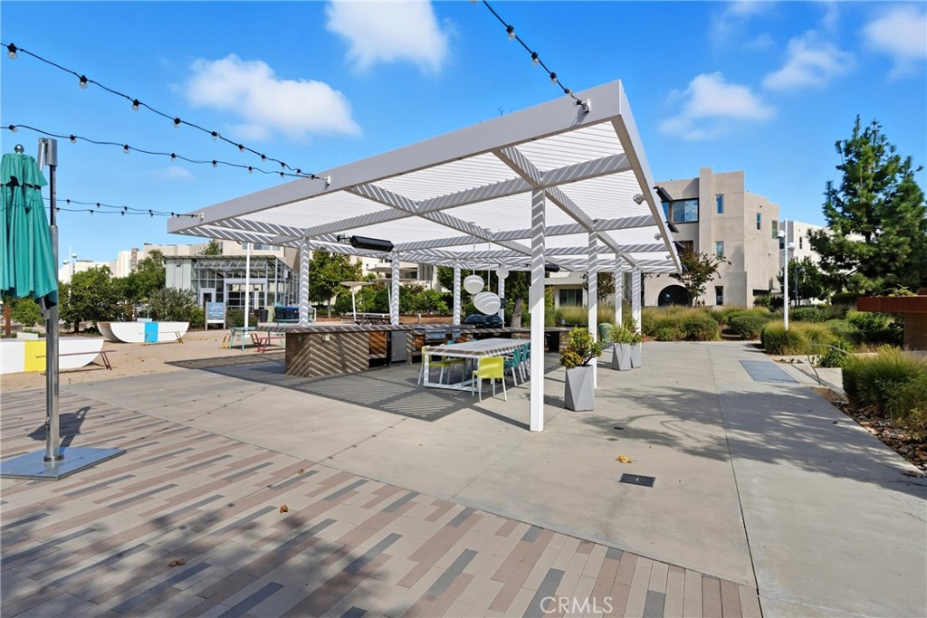 186 Stellar Irvine, CA 92618 - Photo 34 of 46 a view of a patio with a table and chairs under an umbrella