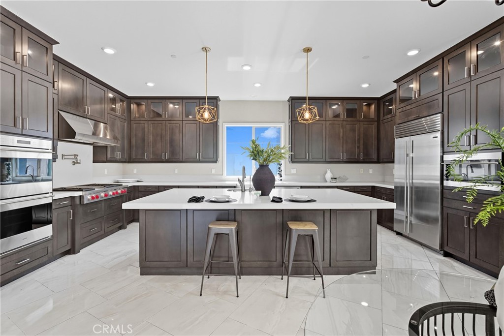 186 Stellar Irvine, CA 92618 - Photo 4 of 46 a kitchen with kitchen island stainless steel appliances a sink and a center island