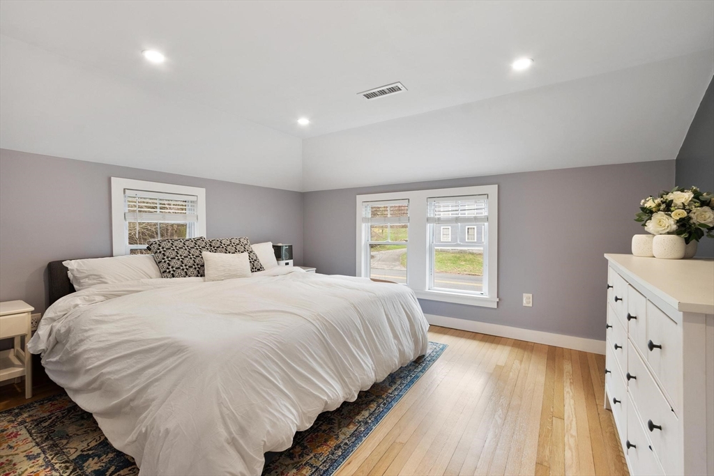 68 Still River Road Harvard, MA 01451 - Photo 22 of 41 a spacious bedroom with a large bed and a window
