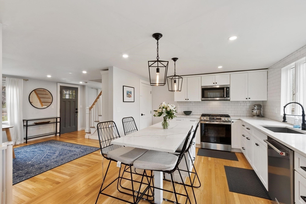 68 Still River Road Harvard, MA 01451 - Photo 10 of 41 a kitchen with stainless steel appliances granite countertop a sink a stove a refrigerator cabinets and chairs