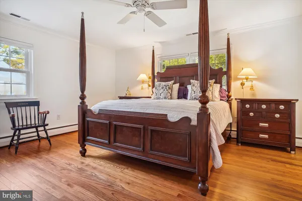 a bedroom with a bed window and a table