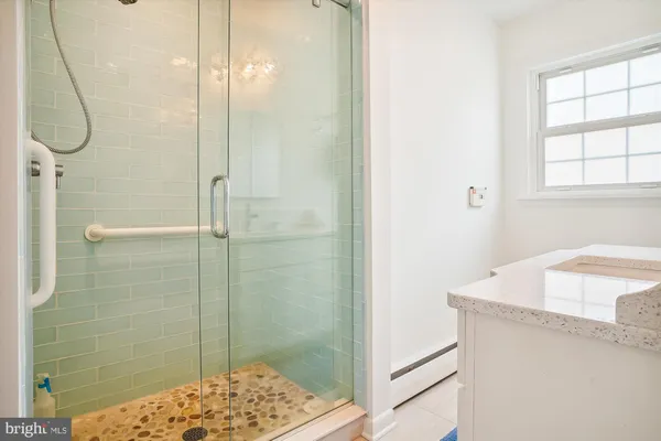 a bathroom with a shower and a sink