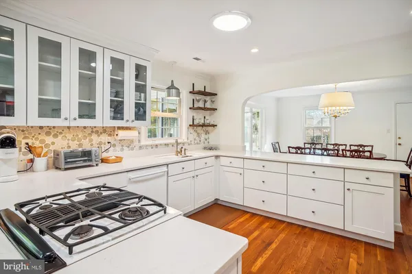 a kitchen with a stove a sink and a microwave