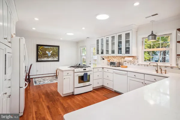 a kitchen with a refrigerator stove and sink