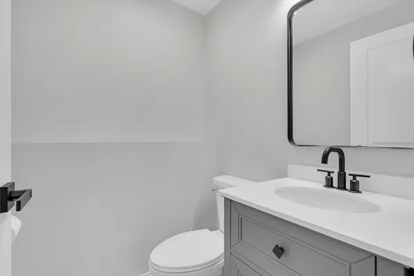 a bathroom with a sink a toilet and mirror