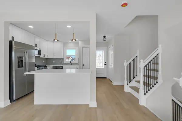 a kitchen with stainless steel appliances a refrigerator and a stove top oven