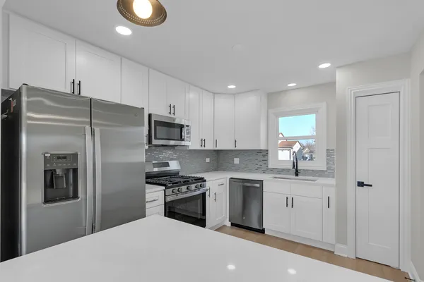 a kitchen with stainless steel appliances a refrigerator stove microwave and sink