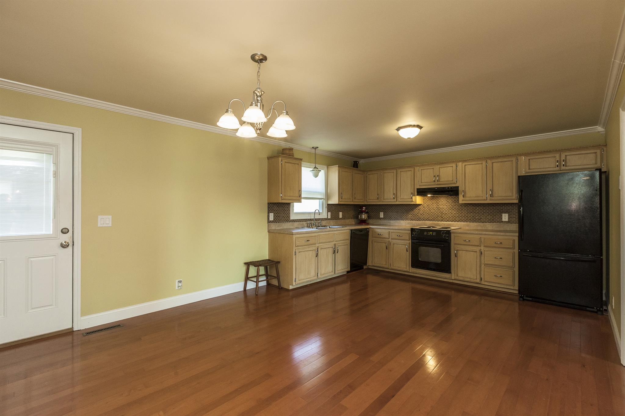 2730 West County Farm Road Springfield, TN 37172 - Photo 12 of 22 a kitchen with a sink wooden floor and stainless steel appliances