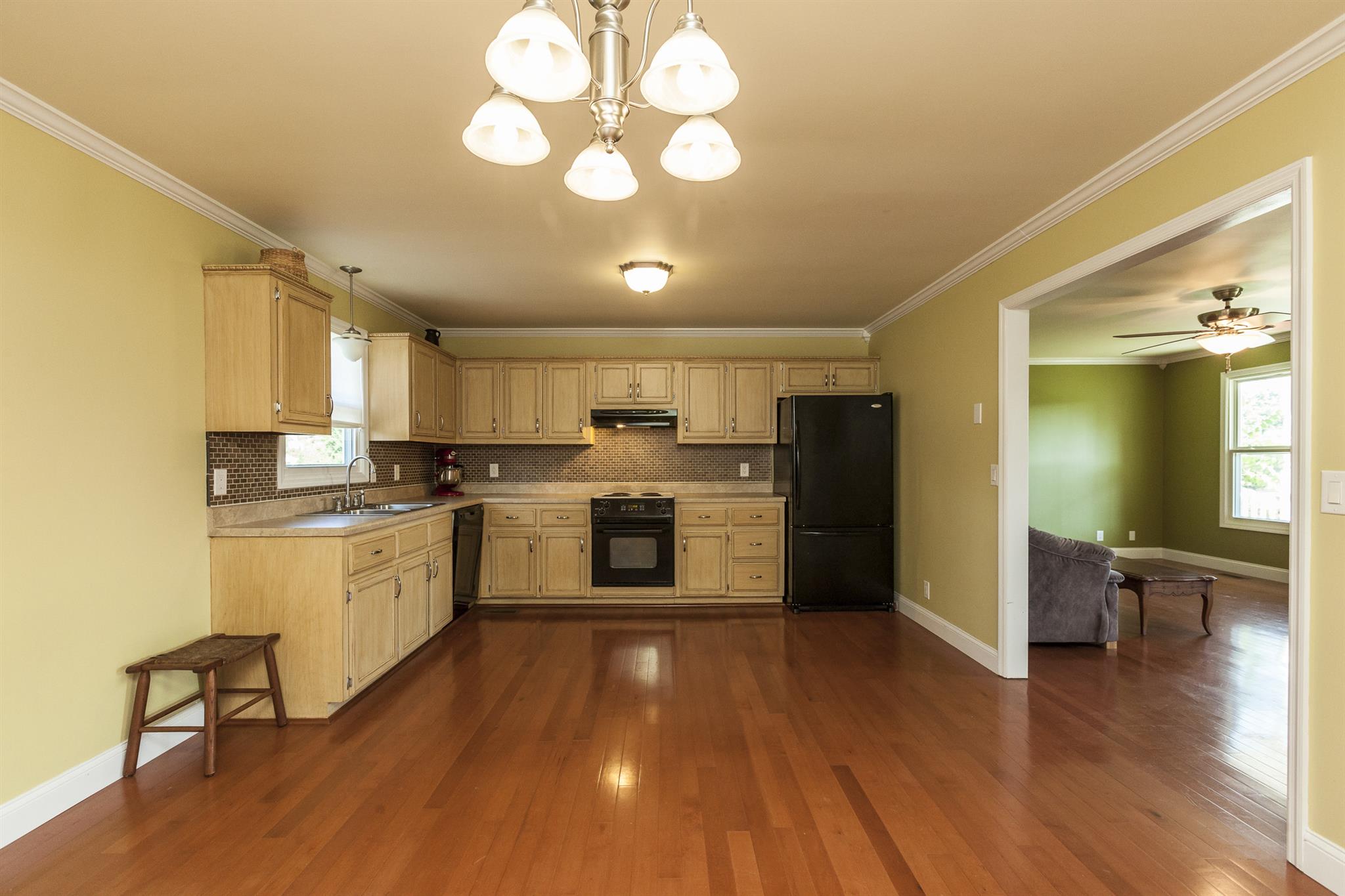 2730 West County Farm Road Springfield, TN 37172 - Photo 13 of 22 a kitchen with a chandelier and wooden floors