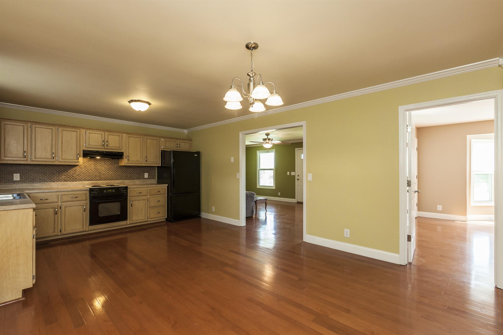 2730 West County Farm Road Springfield, TN 37172 - Photo 14 of 22 a view of a kitchen with a stove wooden cabinets and wooden floor