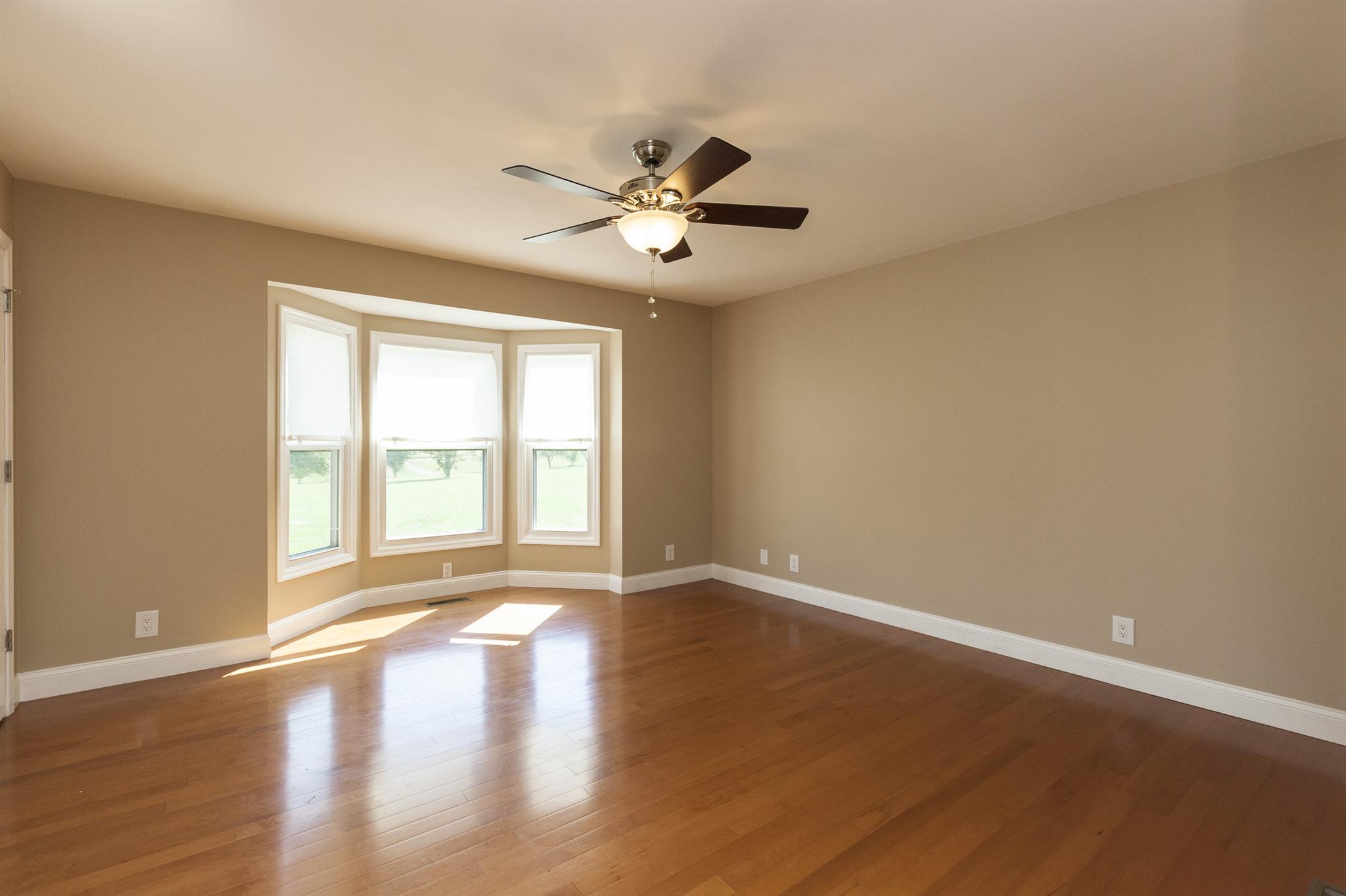 2730 West County Farm Road Springfield, TN 37172 - Photo 15 of 22 an empty room with wooden floor fan and windows
