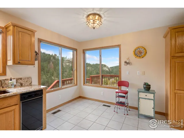a open kitchen with a sink and a refrigerator