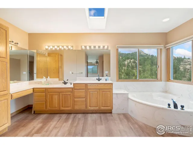 a large bathroom with a large tub and sink