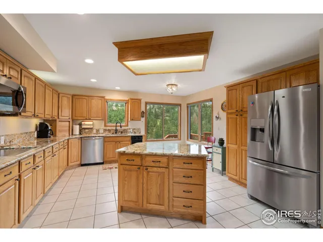 a kitchen with a refrigerator and a sink