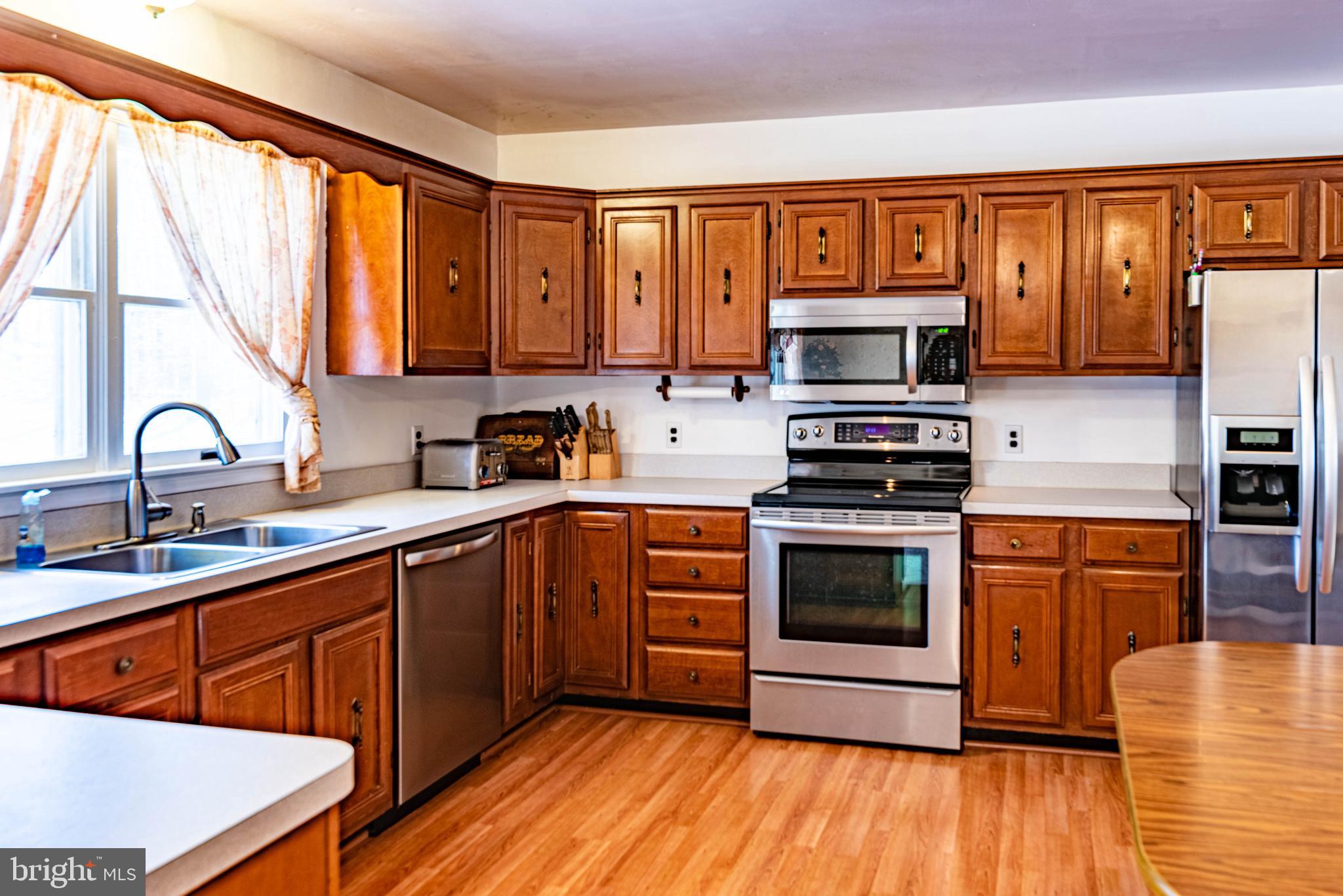 9619 Boyds Turn Road Owings, MD 20736 - Photo 4 of 69 a kitchen with stainless steel appliances a stove sink microwave and refrigerator