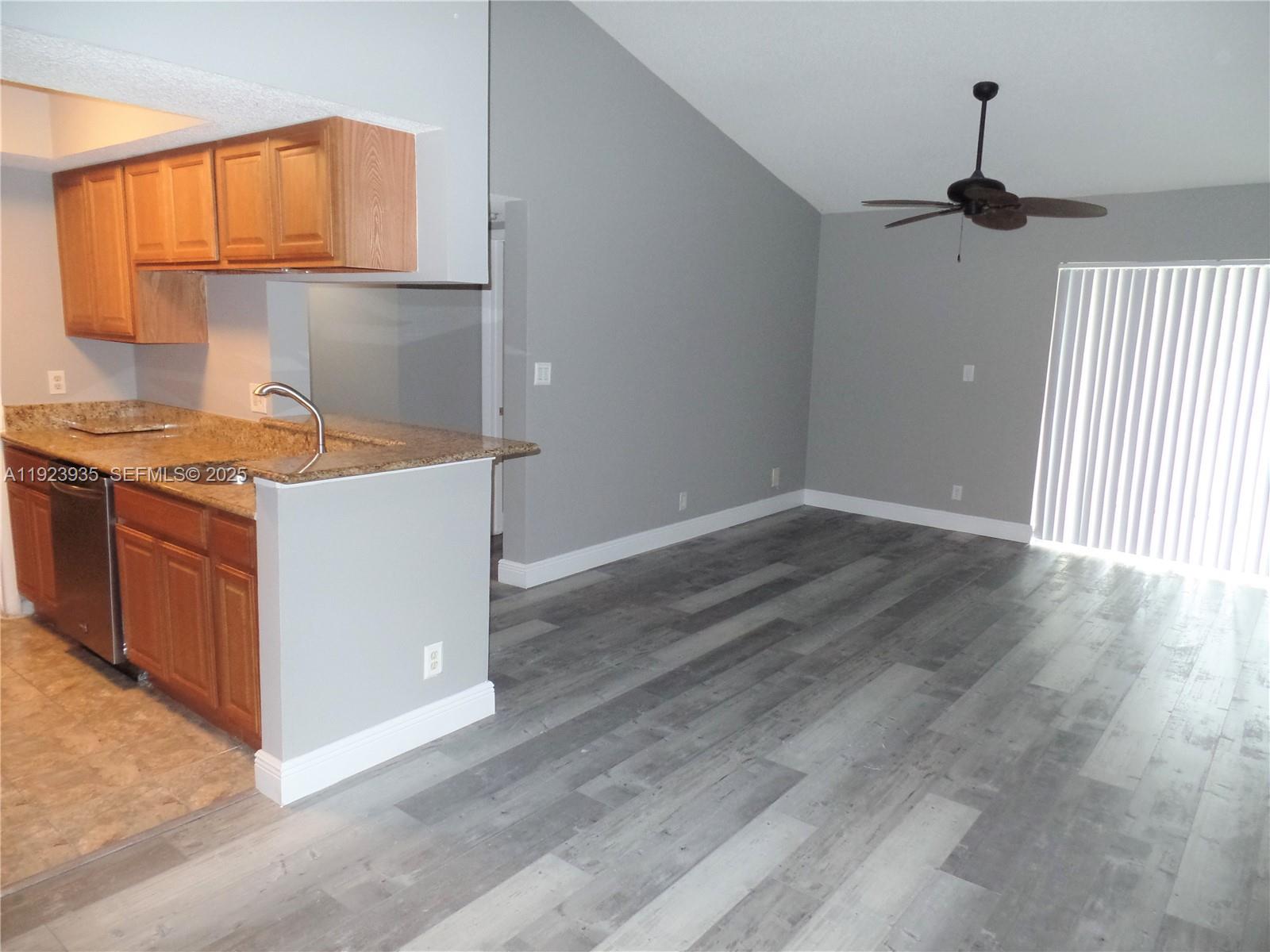 5612 Rock Island Road, Unit 151 Tamarac, FL 33319 - Photo 1 of 26 an empty room with wooden floor cabinets and entryway