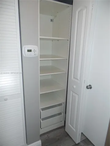 a view of walk in closet with empty racks