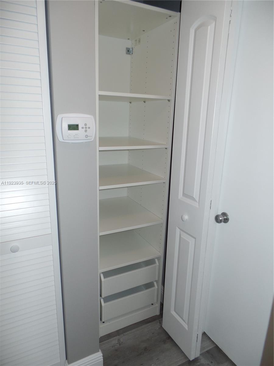 5612 Rock Island Road, Unit 151 Tamarac, FL 33319 - Photo 11 of 26 a view of walk in closet with empty racks