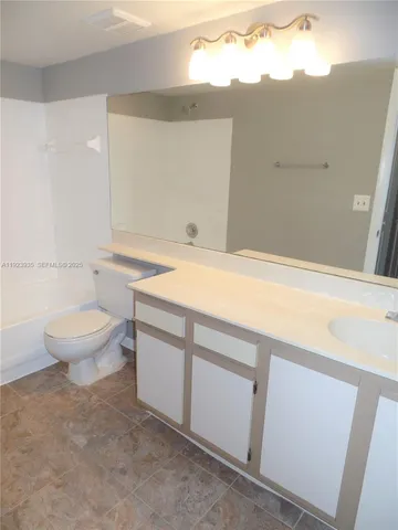 a bathroom with a sink a toilet and a bathtub