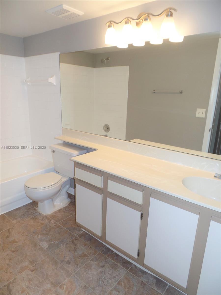 5612 Rock Island Road, Unit 151 Tamarac, FL 33319 - Photo 13 of 26 a bathroom with a sink a toilet and a bathtub