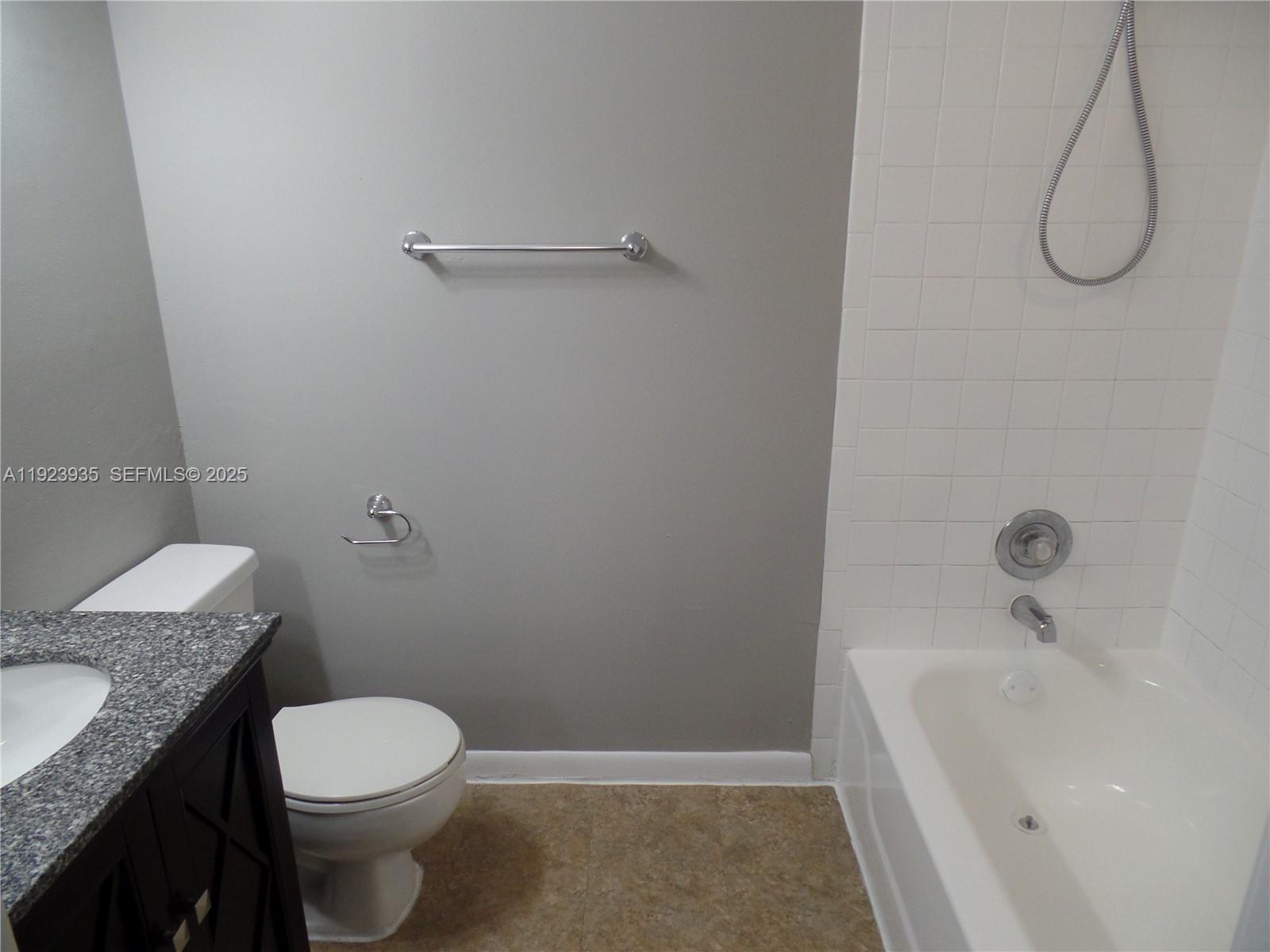 5612 Rock Island Road, Unit 151 Tamarac, FL 33319 - Photo 14 of 26 a bathroom with a granite countertop toilet and a sink
