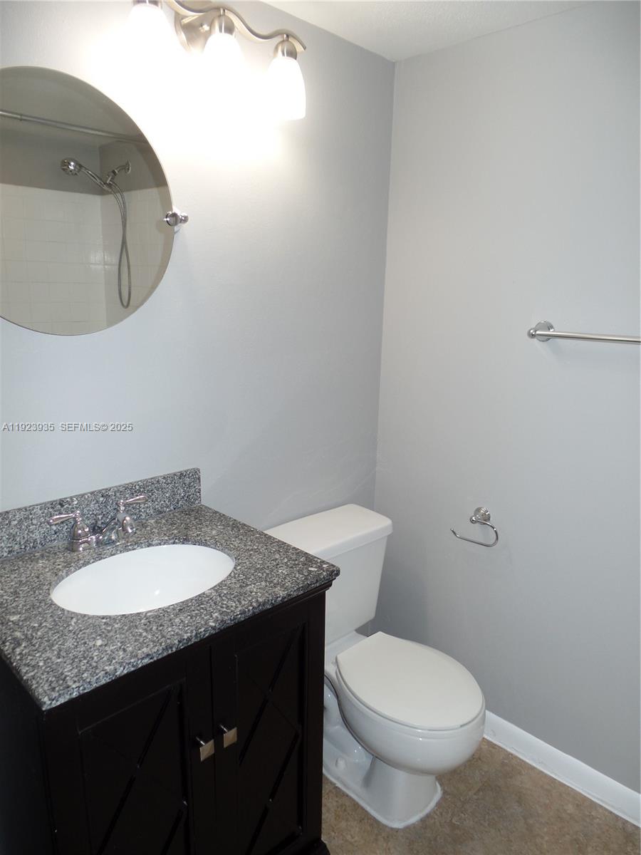5612 Rock Island Road, Unit 151 Tamarac, FL 33319 - Photo 15 of 26 a bathroom with a granite countertop sink and a mirror