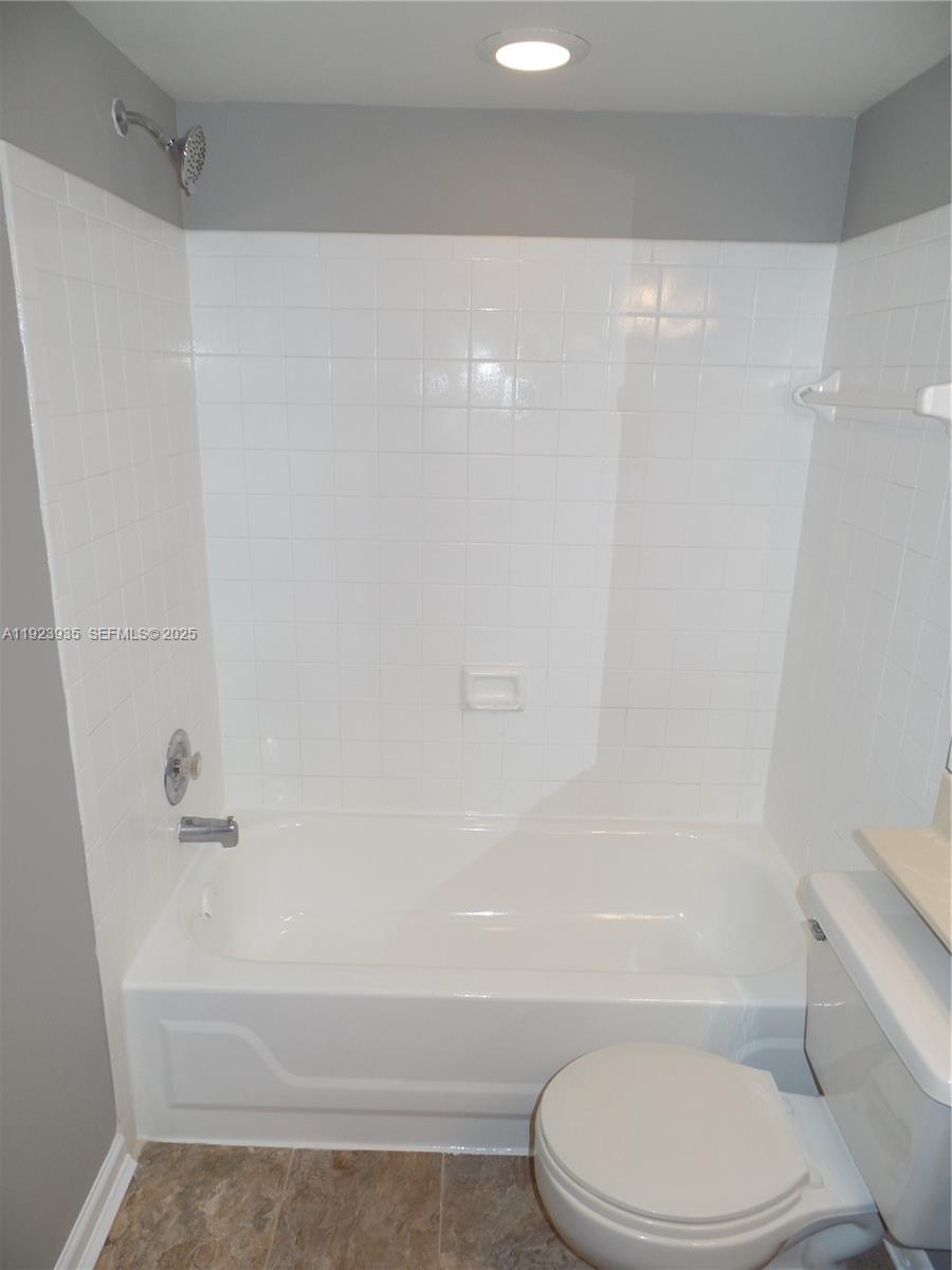 5612 Rock Island Road, Unit 151 Tamarac, FL 33319 - Photo 16 of 26 a bathroom with a toilet and a bathtub
