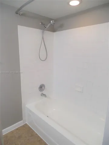 a bathroom with a bath tub with a shower