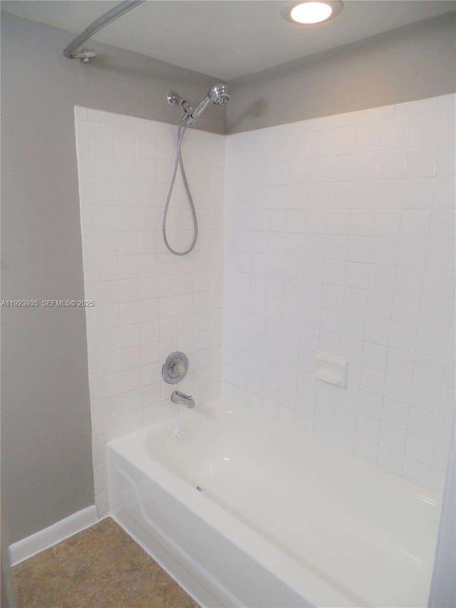 5612 Rock Island Road, Unit 151 Tamarac, FL 33319 - Photo 17 of 26 a bathroom with a bath tub with a shower