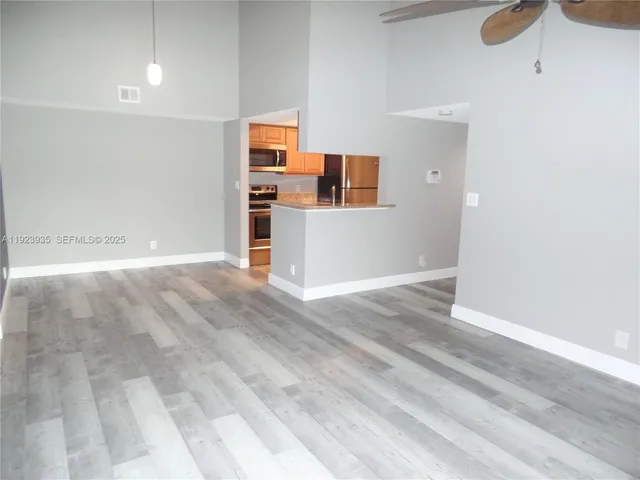 a view of a kitchen with wooden cabinet and a sink