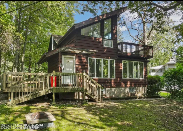 a view of a house with a small yard and furniture
