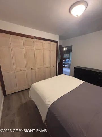 a bedroom with a bed and a night stand