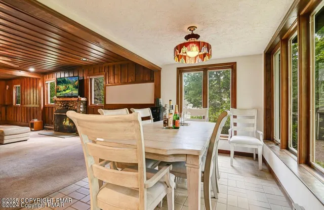 a dining room with furniture a chandelier and wooden floor