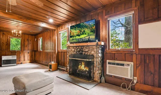 a living room with furniture a fireplace and a window