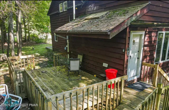 a patio with table and chairs and potted plants