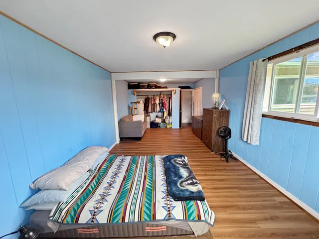a bed room with furniture and a wooden floor