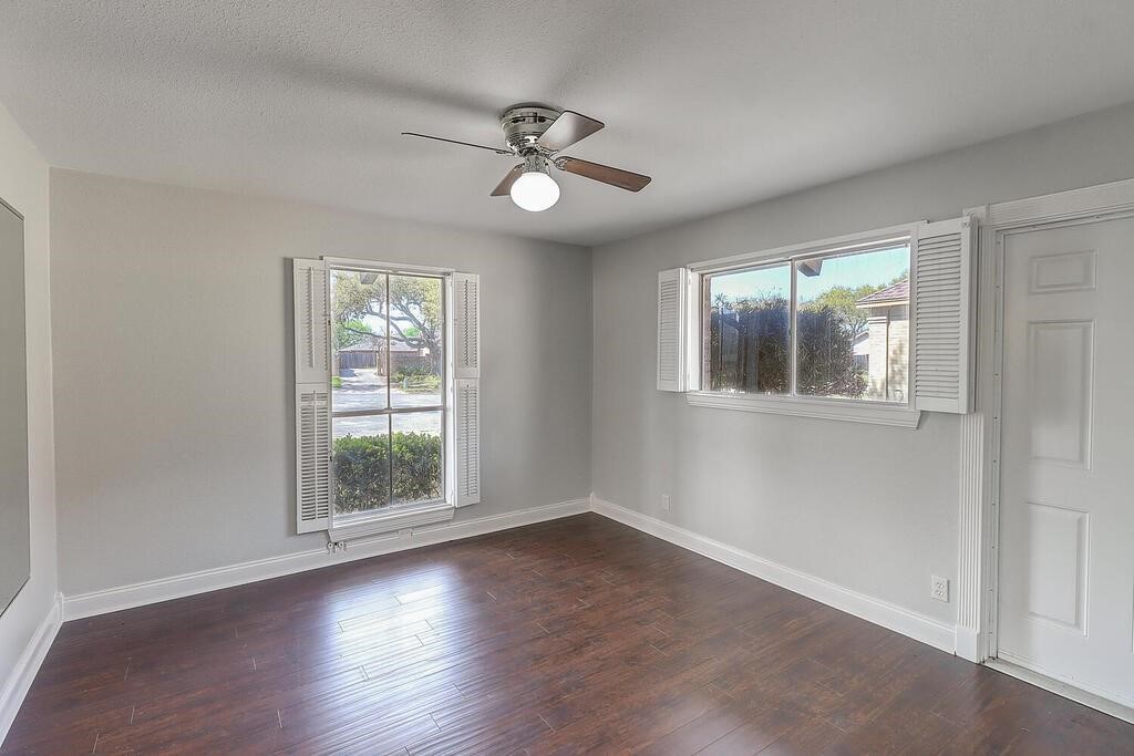 6426 Long Circle Corpus Christi, TX 78413 - Photo 11 of 40 a view of an empty room with wooden floor and a window