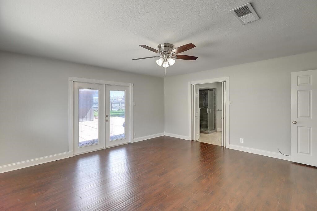 6426 Long Circle Corpus Christi, TX 78413 - Photo 13 of 40 a view of an empty room with a window and wooden floor