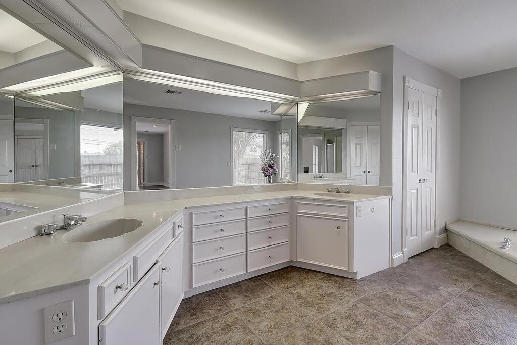 6426 Long Circle Corpus Christi, TX 78413 - Photo 21 of 40 a spacious bathroom with a granite countertop sink mirror and double