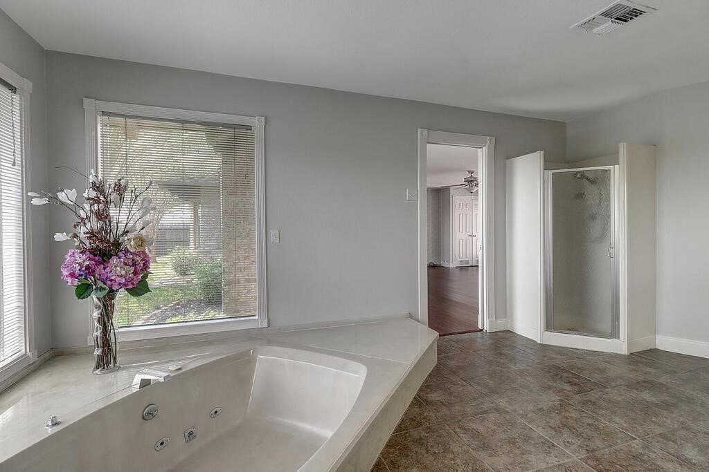 6426 Long Circle Corpus Christi, TX 78413 - Photo 23 of 40 a bathroom with a bathtub and a shower