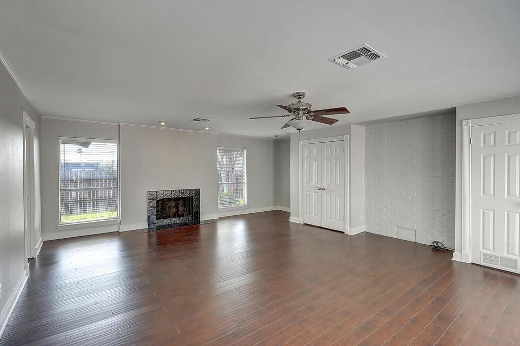 6426 Long Circle Corpus Christi, TX 78413 - Photo 25 of 40 an empty room with wooden floor fireplace and windows