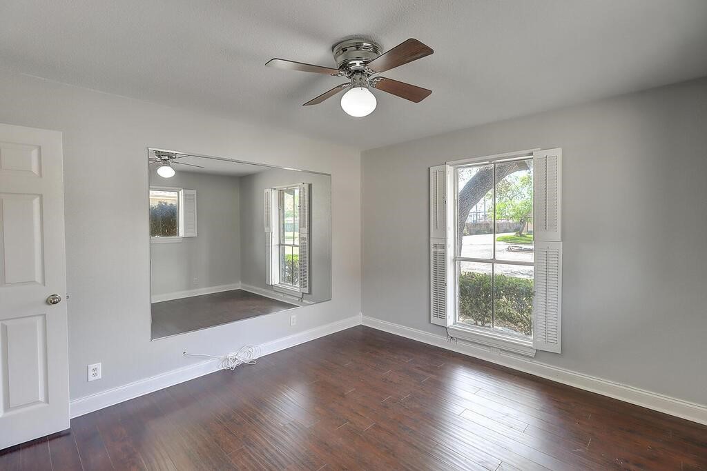 6426 Long Circle Corpus Christi, TX 78413 - Photo 29 of 40 a view of an empty room with a window and wooden floor