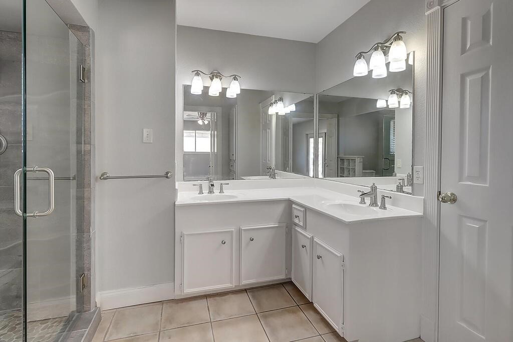 6426 Long Circle Corpus Christi, TX 78413 - Photo 30 of 40 a bathroom with a double vanity sink and a mirror