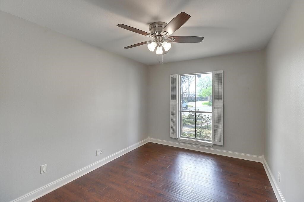 6426 Long Circle Corpus Christi, TX 78413 - Photo 9 of 40 an empty room with wooden floor fan and windows