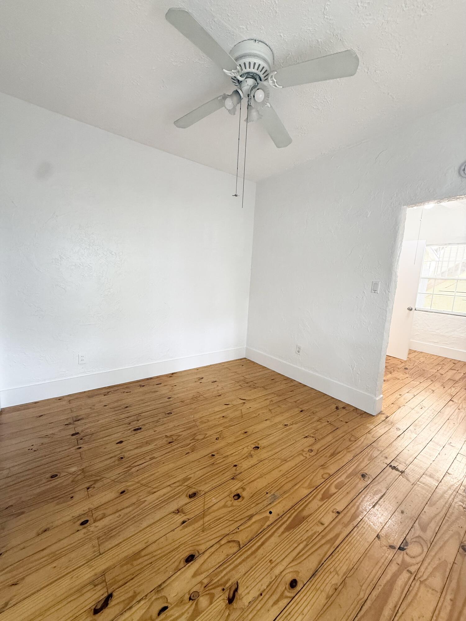 311 Wildermere Road West Palm Beach, FL 33401 - Photo 26 of 87 a view of empty room with wooden floor and fan