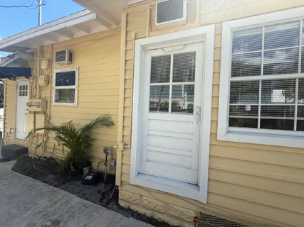 a view of a livingroom with wooden floor and a ceiling fan