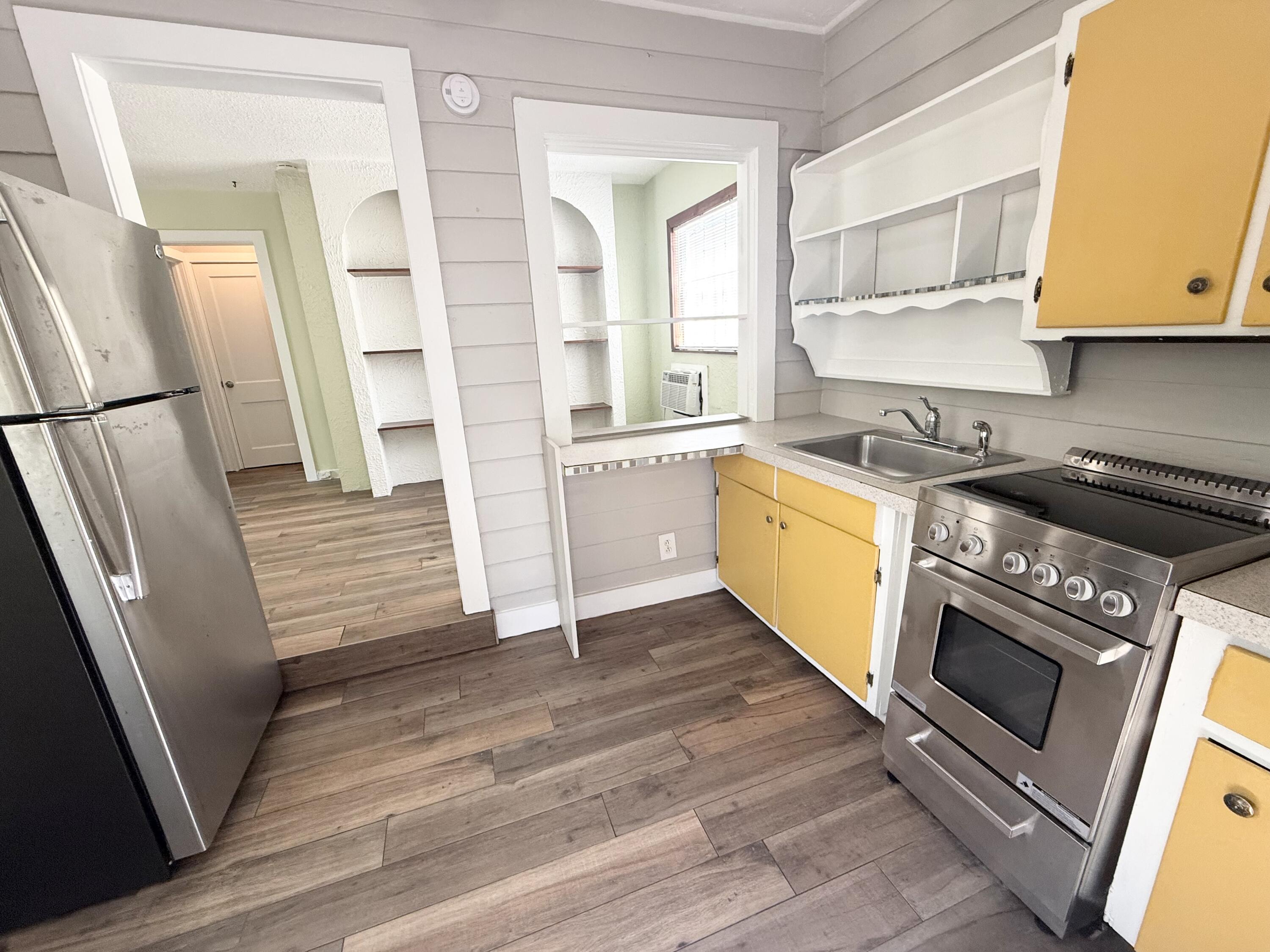 311 Wildermere Road West Palm Beach, FL 33401 - Photo 51 of 87 a kitchen with stainless steel appliances granite countertop a stove a refrigerator and a cabinets