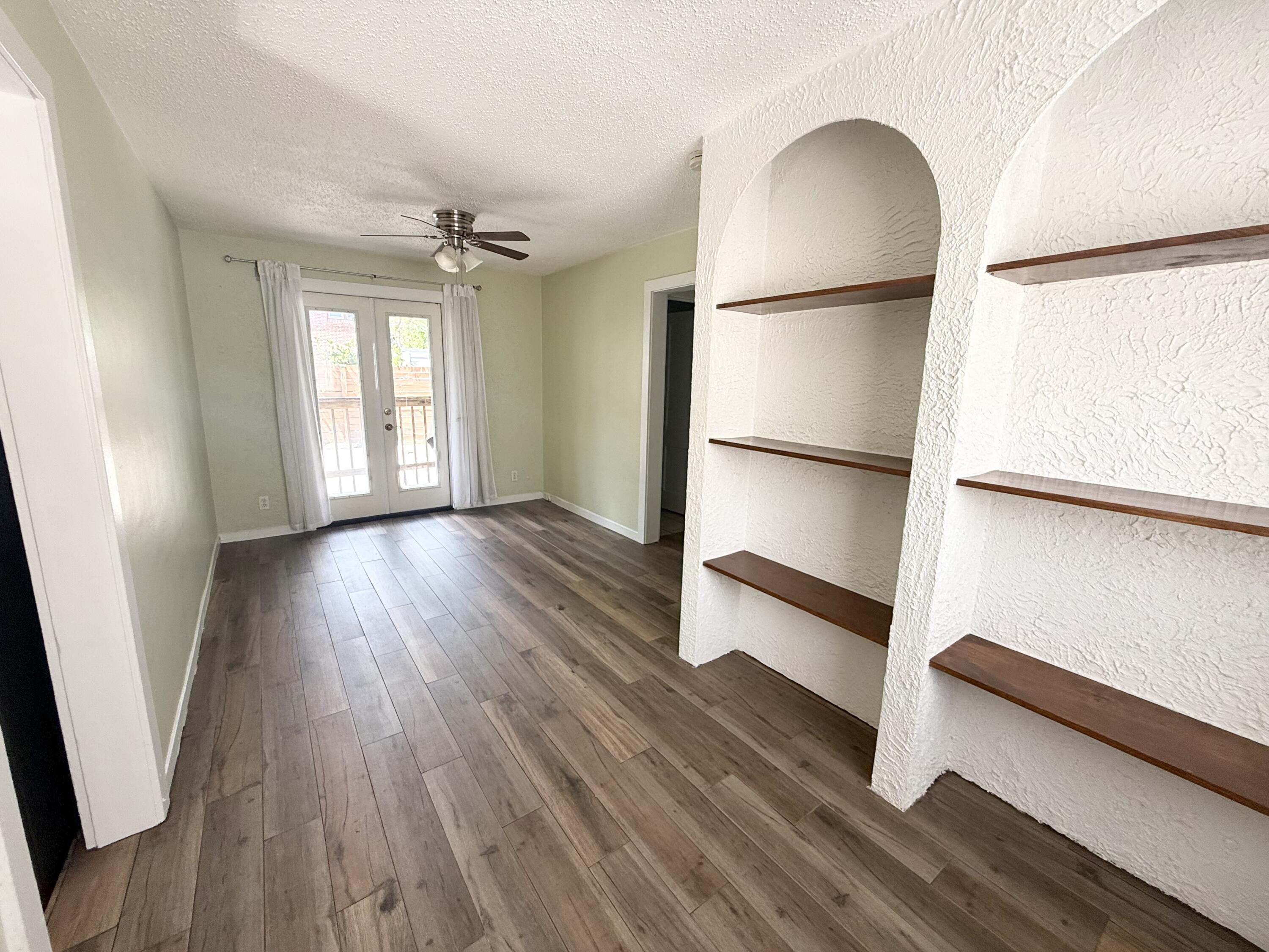 311 Wildermere Road West Palm Beach, FL 33401 - Photo 55 of 87 a view of an empty room with a window and wooden floor