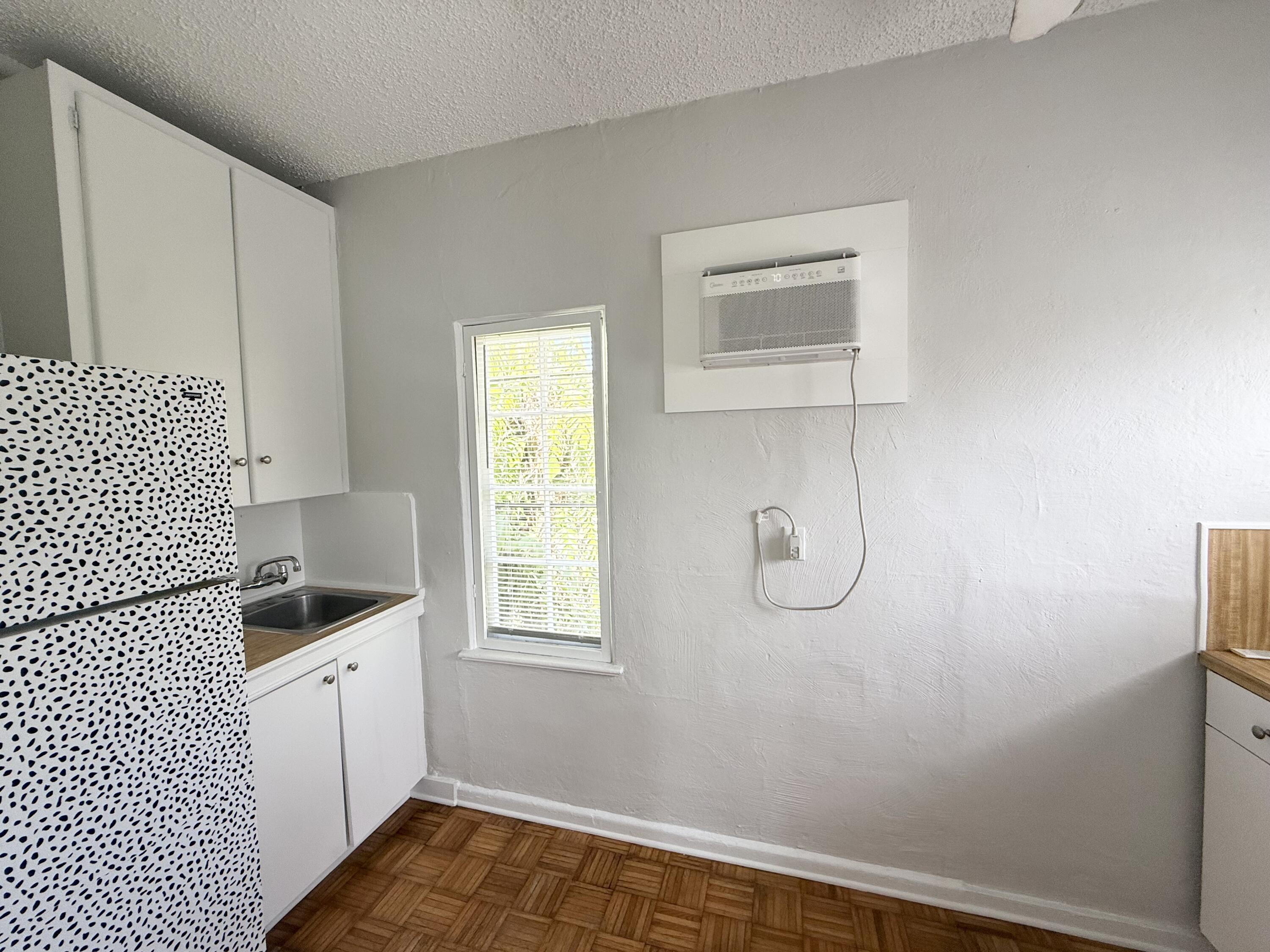 311 Wildermere Road West Palm Beach, FL 33401 - Photo 69 of 87 a bathroom with a granite countertop sink a window and vanity