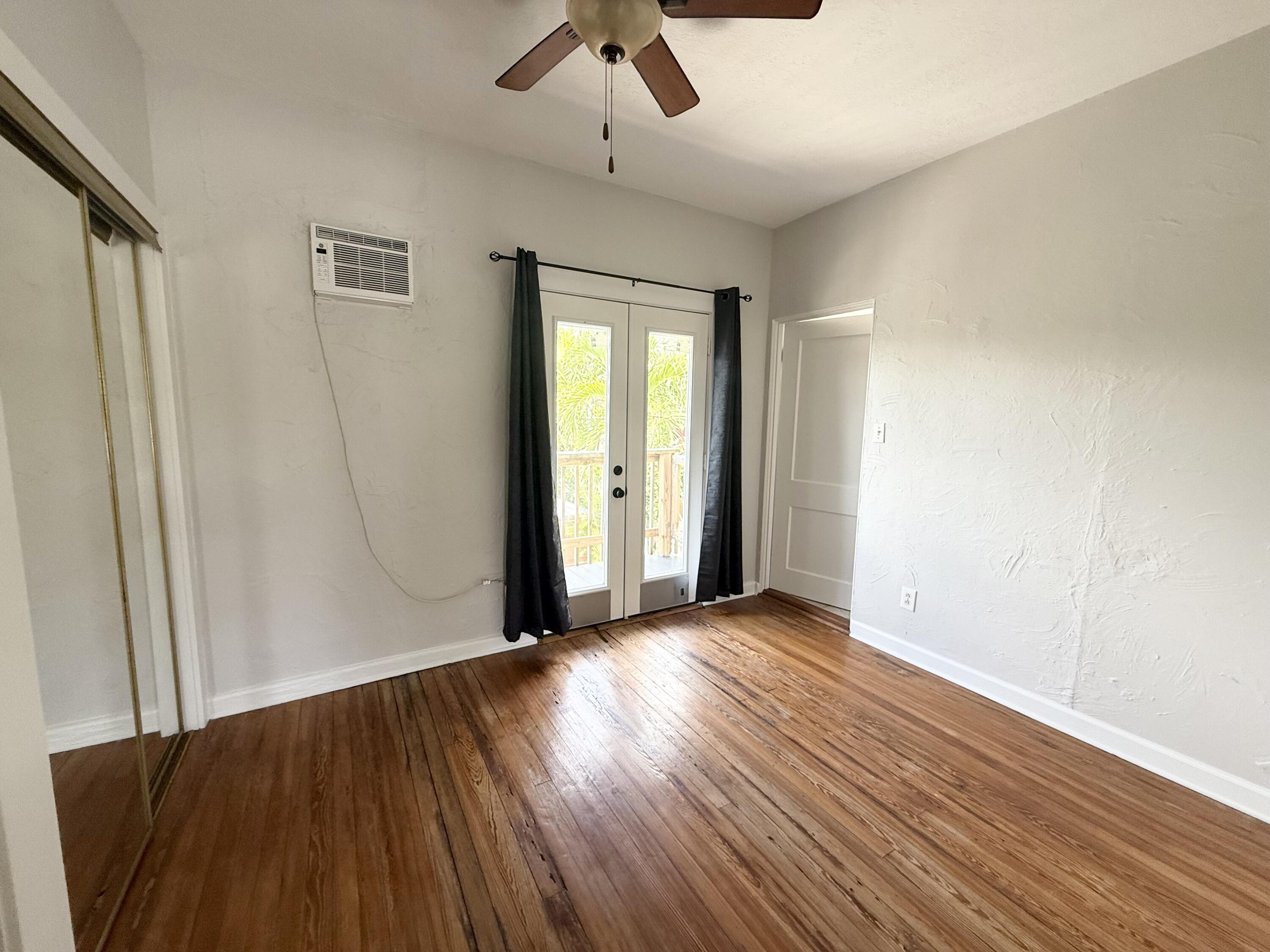 311 Wildermere Road West Palm Beach, FL 33401 - Photo 73 of 87 a view of an empty room with wooden floor and a window